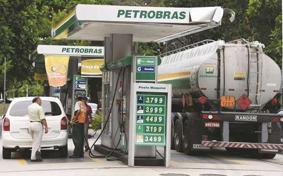 A man fuels up his car at a Petrobras station in downtown Rio de Janeiro (file). While Petrobras has gained under the present governmentu2019s push to unwind nationalistic oil regulations, thereu2019s no guarantee the next president u2013 set to be elected in October 2018 u2013 will follow suit.