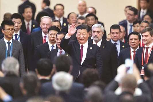 Chinau2019s President Xi Jinping (centre) arrives with leaders at the opening ceremony of the u201cCPC in dialogue with world political partiesu201d high-level meeting, at the Great Hall of the People in Beijing (file). Xi has indicated he is willing to accept lower growth as China tackles financial risk and heavy pollution, with analysts saying he emphasised the point by leaving growth targets out of his speech to party delegates in October.