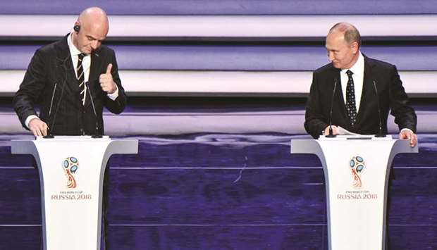 FIFA president Gianni Infantino (left) and Russian president Vladimir Putin speak on stage ahead of the draw for the 2018 FIFA World Cup at the Kremlin Palace in Moscow yetserday. (AFP)