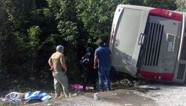 Mexican police officers and paramedics work in the scene of a road accident in Quintana Roo state