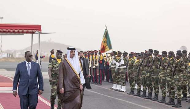 His Highness the Emir Sheikh Tamim bin Hamad al-Thani, accompanied by Senegal's President Macky Sall, inspects guard of honor during the official reception ceremony upon his arrival in Dakar on an official visit to the Republic of Senegal.