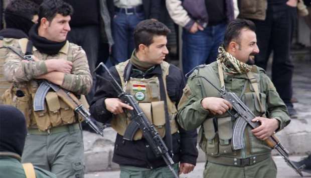 Iraqi Kurdish security forces stand guard