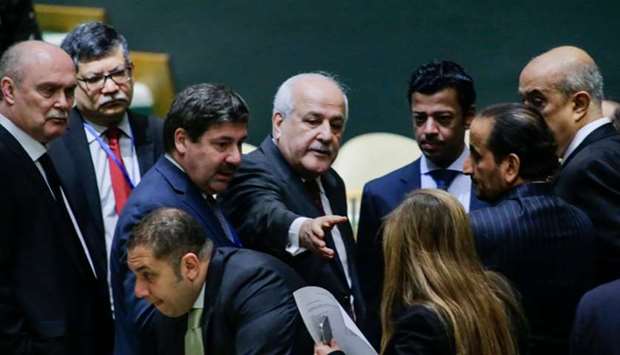 Riyad H. Mansour, (C) Palestine's Ambassador to the United Nations speaks with delegates as he arrives to the General Assembly Hall before the vote on Jerusalem