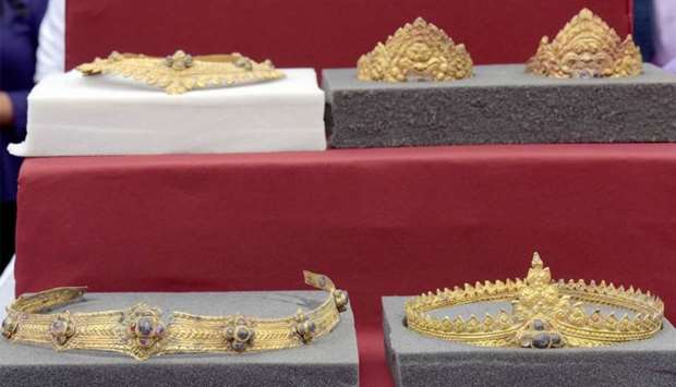 A set of returned Angkorian-era gold jewellery is displayed to the public behind protective glass during a ceremony