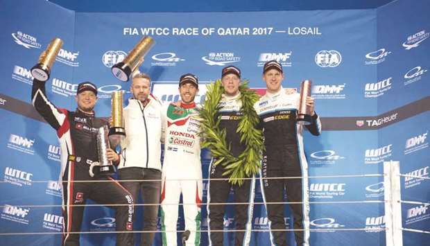 Thed Bjork (second from right) celebrates his title victory on the podium with World Tour Car Championship Main Race winner Esteban Guerrieri (centre), runner-up Rob Huff (left), third-placed Nicky Catsburg (right) and Hondau2019s Tiago Monteiro yesterday.