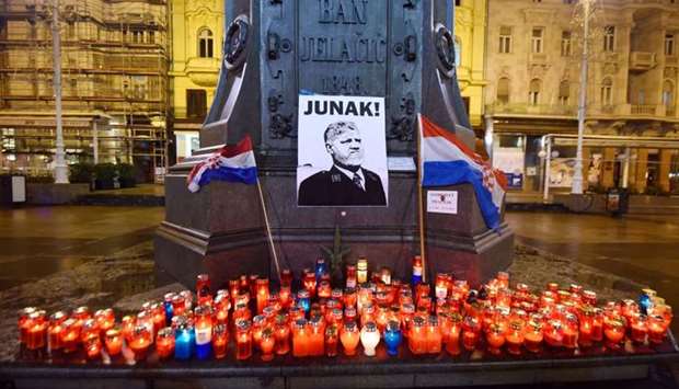 Lit candles and flags are placed in tribute to General Slobodan Praljak in Zagreb on November 30, 2017, after he took his own life in front of United Nations war crimes judges, apparently drinking poison.