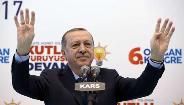 Turkish President Tayyip Erdogan greets his supporters during a meeting of his ruling AK Party in Kars, Turkey