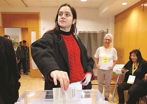 18-year-old Laura Sancho, voting for the first time, casts Puigdemontu2019s proxy vote at a polling station in Sant Cugat del Valles, Spain