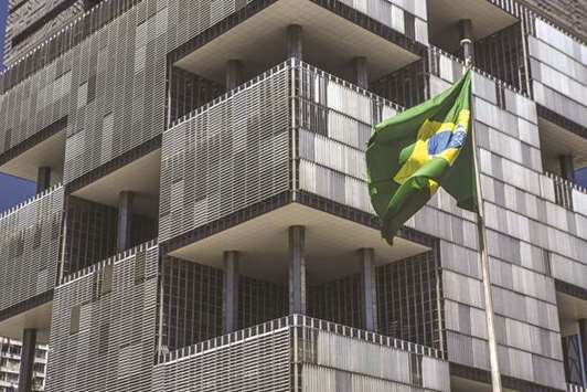 A Brazilian national flag waves outside the Petroleo Brasileiro (Petrobras) headquarters in Rio de Janeiro. Brazilu2019s gross domestic  product expanded 0.1% from the second quarter and 1.4% from the previous year, the national statistics agency said on Friday.