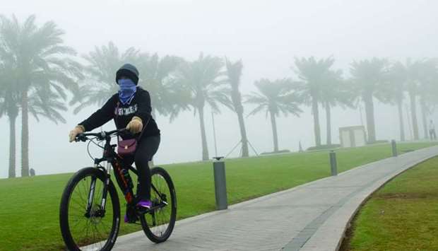A lone cyclist braves the fog during a ride through the MIA Park Friday morning. PICTURE: Noushad Thekkayil.