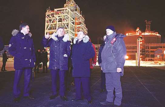 Russian President Vladimir Putin is escorted by Energy Minister Alexander Novak and co-owner of Russian gas producer Novatek Leonid Mikhelson, as he inspects a construction site of Yamal LNG, Russiau2019s second liquefied natural gas plant, in the Arctic port of Sabetta, Yamalo-Nenets district, Russia. Opec and Russia will exit from oil production cuts very smoothly, possibly extending the curbs in some form to avoid creating any new surplus in the market, the Russian energy minister told Reuters yesterday.
