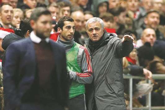 Manchester United manager Jose Mourinho speaks with Henrikh Mkhitaryan before sending him on as a substitute during the League Cup quarter-final against Bristol on Wednesday. (Reuters)