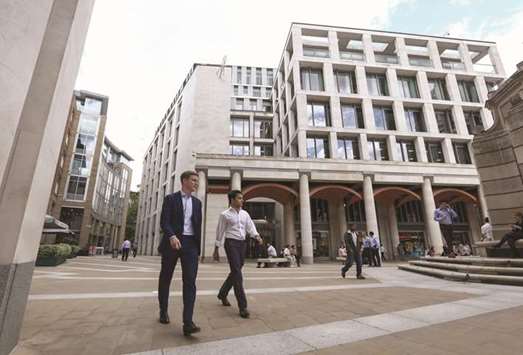 Pedestrians pass the London Stock Exchange offices in Paternoster Square in London. Bruised by the collapse of its merger with Deutsche Boerse and battered by the abrupt departure of its CEO, the LSE may find Brexit buys it time get its house in order.
