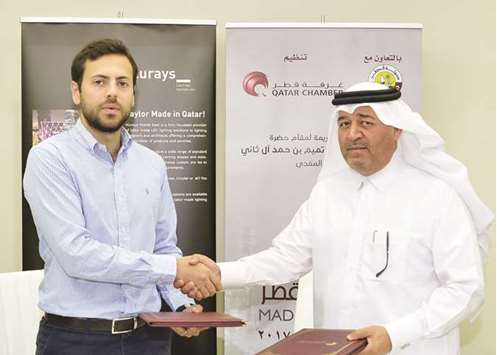 Qatar Chamber head of Administrative and Financial Affairs Hussain Yousef al-Abdul Ghani and Alurays operations manager Feras Abdul Majid shake hands after signing the sponsorship agreement at the Chamberu2019s headquarters on Thursday.