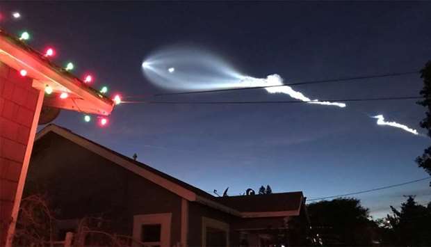 SpaceX's Falcon 9 rocket lifts off in the air, as seen from El Sugundo, California