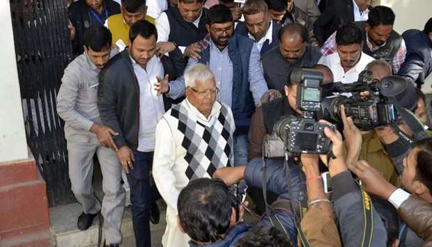 Former chief minister of Bihar state Lalu Prasad Yadav (C) walks as he has being taken to police custody after found guilty at a special CBI Court in Ranchi.  AFP