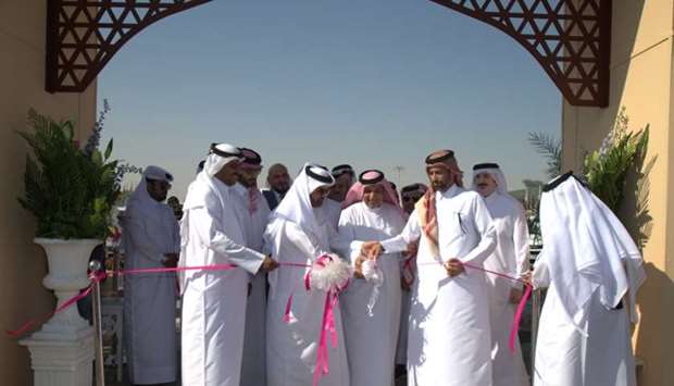 HE Sheikh Dr Faleh bin Nasser al-Thani and Dr Khalid bin Ibrahim al-Sulaiti lead the ribbon cutting ceremony at the opening of Mahaseel Festival at the southern area of Katara. -supplied picture