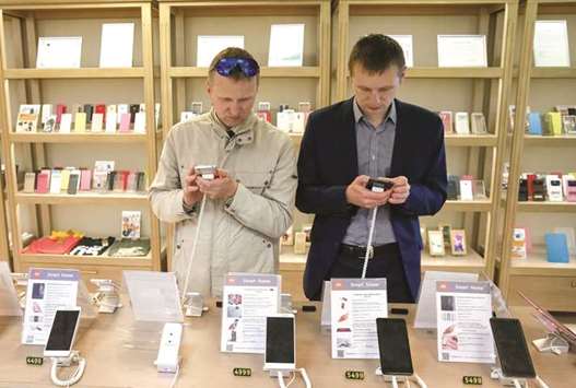 Men try out Xiaomi smartphones at the companyu2019s store in central Kiev, Ukraine. The company, which has been hearing bank pitches for what could be the worldu2019s biggest tech float next year, will rake in a net profit of at least $1bn in 2017, banker projections based on the companyu2019s revenue estimate of $17bn to $18bn show.