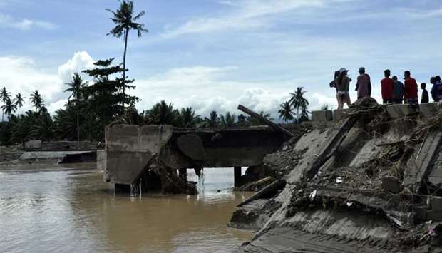 Residents looking at the Cabuyao Bridge, which collapsed after being hit by Tropical Storm Tembin, in Barangay Dalama, Tubod, Lanao del Norte on the southern Philippine island of Mindanao.