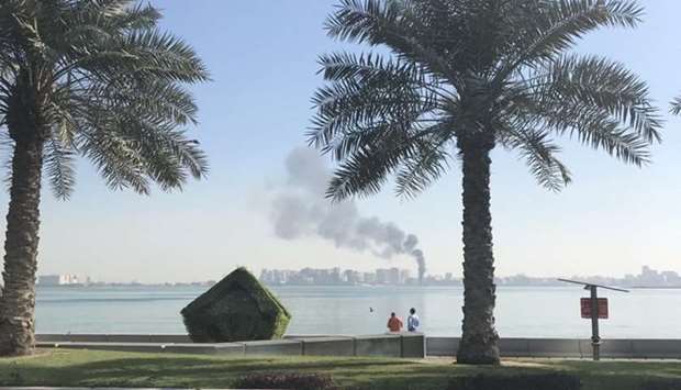 Smoke rising from a boat that caught fire at Doha corniche. Picture posted on Twitter by Graham A