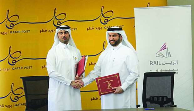 Mohamed Jabr al-Naemi and Khalifa Hassan al-Jehani at the signing