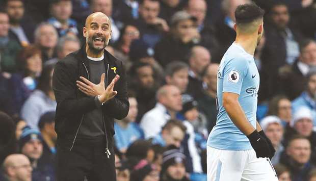 Manchester City manager Pep Guardiola (left) talks to forward Sergio Aguero during the Premier League match against Bournemouth on Saturday. (Reuters)