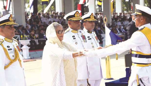 Prime Minister Sheikh Hasina handing over a certificate of merit to a midshipman at a ceremony at Navy Parade Ground in southeastern port city of Chittagong yesterday.