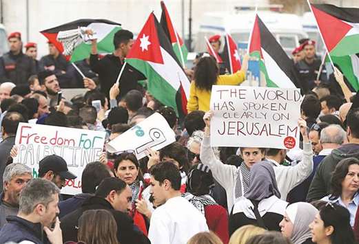 Protesters shout slogans and wave flags during a demonstration near the American embassy in the Jordanian capital Amman, on December 22, as protests continue in the region amid anger over US President Donald Trumpu2019s recognition of Jerusalem as Israelu2019s capital.