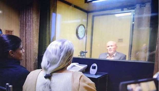The picture released by Pakistan that shows Jadhav's mother, Avanti, and wife, Chetankul seated at a desk and speaking to him from behind a glass window.