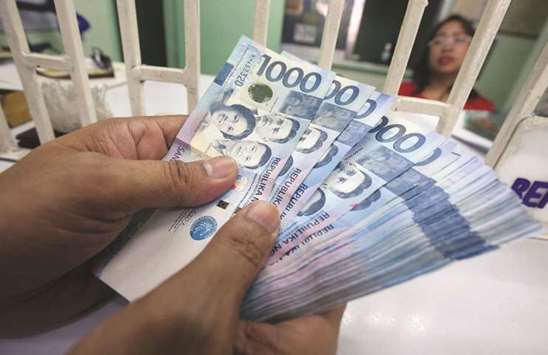 n employee at a money changer counts Philippine peso in Manila. The currency has whipsawed this year, sliding to an 11-year low of 51.85 per dollar in October before paring losses to trade at 50.250 on Friday. It is still down 1.1% since the start of January.