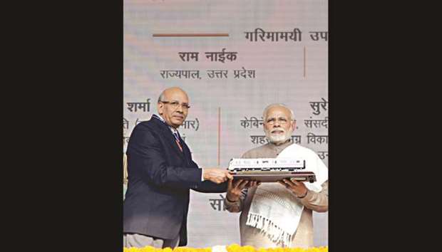 Prime Minister Narendra Modi is gifted a Metro train model during the inauguration of a section of the Delhi Metro in Noida, 25kms east of New Delhi, yesterday.