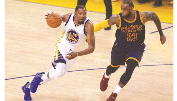 Golden State Warriorsu2019 Kevin Durant (right) drives on the Cleveland Cavaliersu2019 LeBron James during the first quarter of Game 1 of The Finals at Oracle Arena in Oakland, California on June 1, 2017.