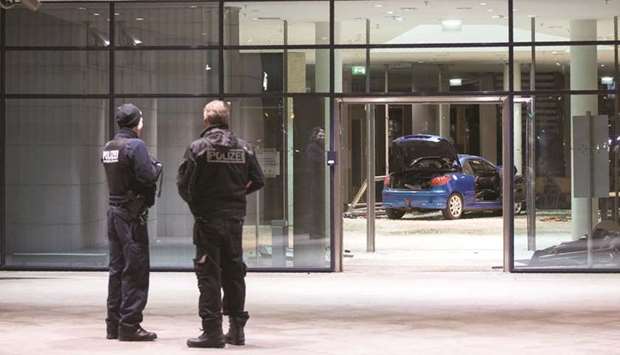 Police officers inspect the damage in the lobby of the German Social Democratic Party (SPD) headquarters.