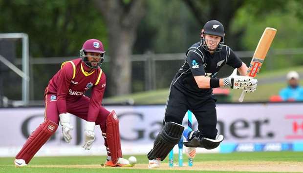 New Zealand's Henry Nicholls (R) bats as West Indies wicketkeeper Shai Hope (L) looks on, during the third one-day international (ODI) cricket match between New Zealand and the West Indies at Hagley Oval in Christchurch.