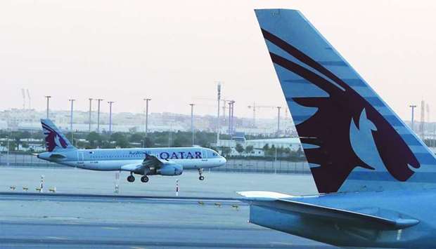 A Qatar Airways plane lands at the Hamad International Airport. Qataru2019s national carrier is one of the fastest-growing airlines operating one of the youngest fleets in the world.