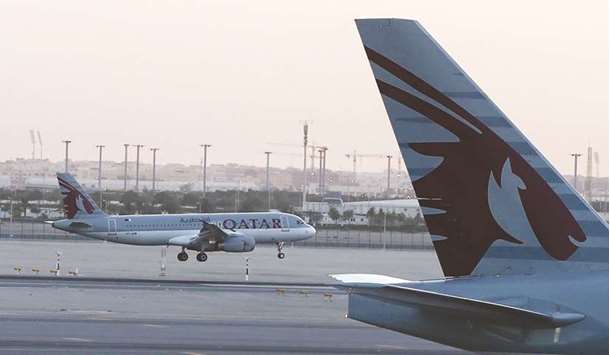 A Qatar Airways plane lands at the Hamad International Airport (file). Qataru2019s national carrier is one of the fastest-growing airlines operating one of the youngest fleets in the world.