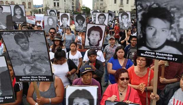 People hold a protest against Peruvian President Pedro Pablo Kuczynski's humanitarian pardon to Peru's jailed ex-president Alberto Fujimori, in Lima.