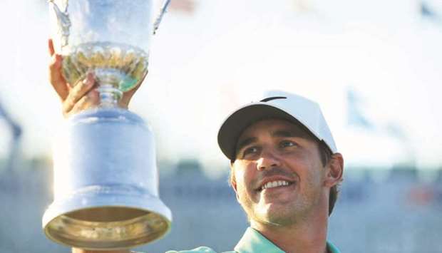 In this June 18, 2017, picture, Brooks Koepka of the United States poses with the winneru2019s trophy after winning the US Open in Hartford, Wisconsin. (AFP)