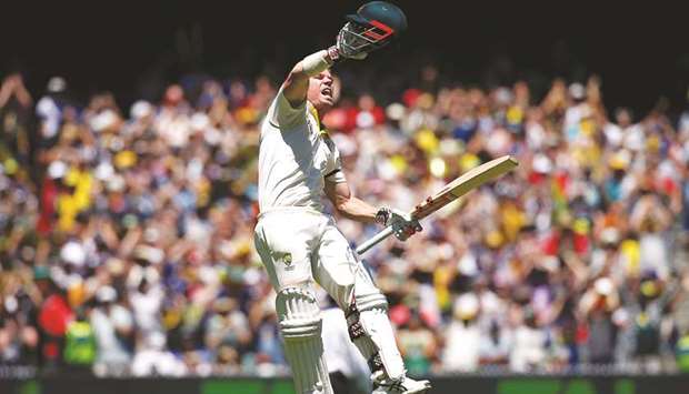Australiau2019s David Warner celebrates reaching his century on Day One of the fourth Ashes Test against England in Melbourne yesterday. (Reuters)