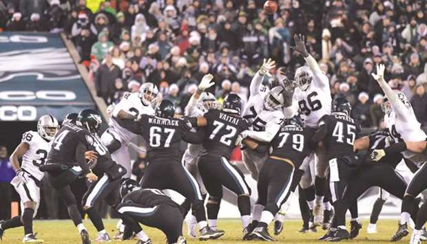 Philadelphia Eagles kicker Jake Elliott (No 4) kicks a 48-yard field goal out of the hold of punter Donnie Jones (No 8) with 27 seconds left in an NFL game against the Oakland Raiders at Lincoln Financial Field. PICTURE: USA TODAY Sports