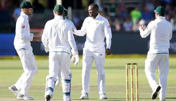 South African bowler Andile Phehlukwayo (2R) celebrates