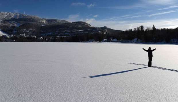 A man poses for a photo on frozen Lake Tremblant in the Laurentides region of Quebec, Canada