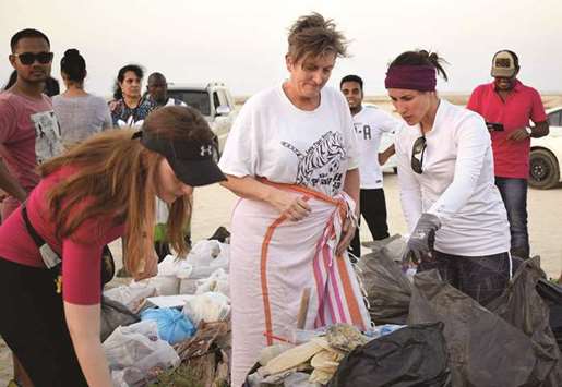DRIVEN: Group of expatriates collecting trash.