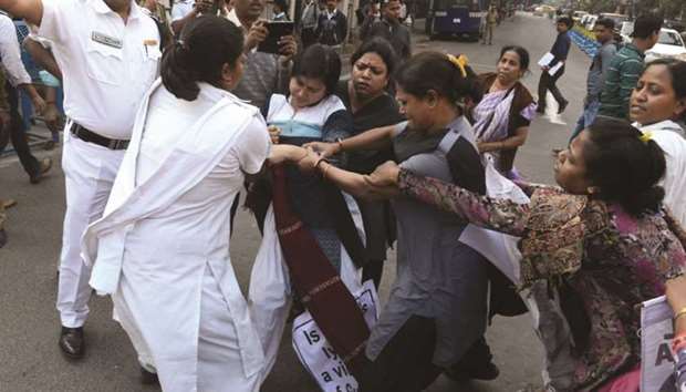 Police stops agitating Socialist Unity Centre of India (SUCI) activists at Raj Bhavan in Kolkata yesterday.