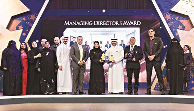 HE the Minister of Public Health Dr Hanan Mohamed al-Kuwari with the Nesmau2019ak team u2013 winners of the Managing Directoru2019s Special Award and the Star of Excellence Award in the Patient Experience category.