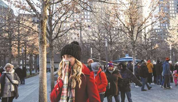 People bundle up against the cold temperature in New York City,