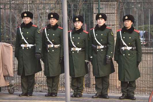 Chinese paramilitary police officers stand guard near a foreign embassy in Beijing. Chinau2019s paramilitary police force will soon be commanded by the Chinese Communist Partyu2019s armed forces, the latest sign of the leadershipu2019s resolve to centralise power.