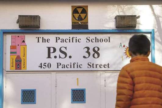 A yellow nuclear fallout shelter sign is seen over the entrance to PS 38 in the Brooklyn borough of New York.