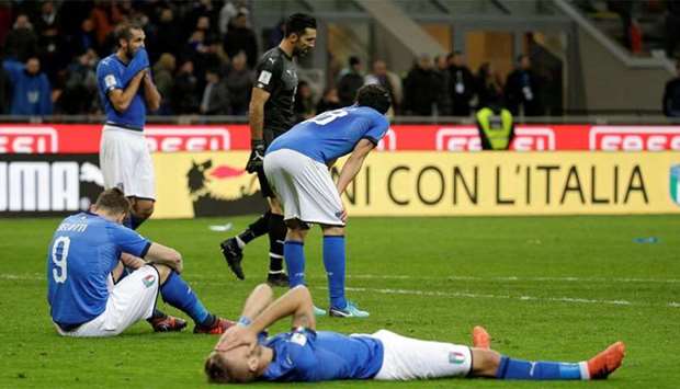Italian players react to their elimination at the end of their World Cup qualifier against Sweden