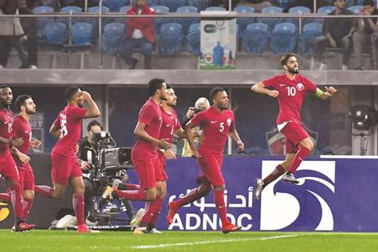 Qataru2019s Hassan al-Haydos (R) celebrates his goal against Bahrain in the Gulf Cup yesterday. Picture at bottom shows fans cheering the Qatari team.